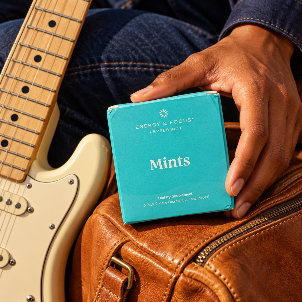 Energy & Focus junto a una guitarra. Campaña creada con IA.